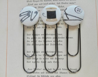 Sewing bookmarks; set of 3 (spool of thread, needles, and safety pins design). Paper clip bookmark is 3 3/4” long.