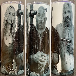 May include: A black and white image of three people from the TV show The Walking Dead. The image is on a white background. The people are holding guns and have blood on their faces and bodies.