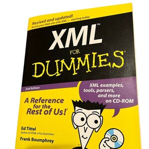 May include: A yellow and black book titled "XML For Dummies" with the text "Revised and updated!" and "A Reference for the Rest of Us!". The cover features a cartoon character holding a CD-ROM. The book is a 2nd edition.