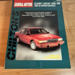 May include: A blue and green repair manual for General Motors vehicles, including the Celebrity, Century, Ciera, and 6000 models. The manual covers models from 1982 to 1995. The cover features a red car and the text "Chilton's".