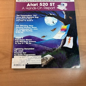 May include: An October 1985 issue of COMPUTE! magazine, focusing on home computing, including Atari 520 ST. The cover art shows a night scene with a tree, moon, and computer-related graphics. The magazine's cover has a purple banner.