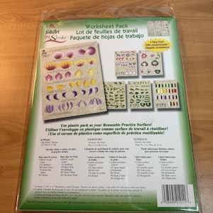 May include: A FolkArt One Stroke worksheet pack with floral and leaf designs. The pack includes multiple practice sheets with various color palettes and instructions. The plastic packaging can be used as a reusable practice surface.