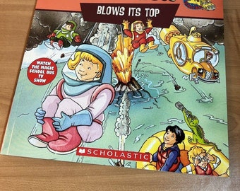 May include: A yellow school bus with a red roof and the words "The Magic School Bus" and "Blows Its Top" on the cover of a book. The book is published by Scholastic.
