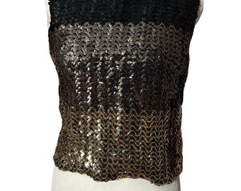 May include: A sleeveless sequined top with a black top section and a gold and silver gradient bottom section.