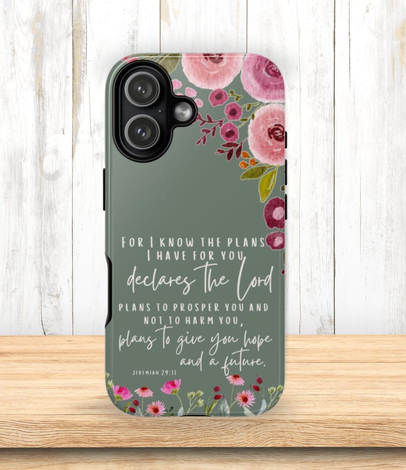 May include: A phone case with a floral design and a quote from Jeremiah 29:11. The case features pink and burgundy flowers on a sage green background. The quote reads, "For I know the plans I have for you, declares the Lord..."