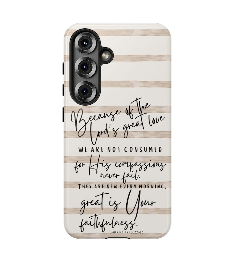 May include: A phone case with a white and beige striped background. The case features the text "Because of the Lord's great love...great is Your faithfulness." The case has a black camera module.