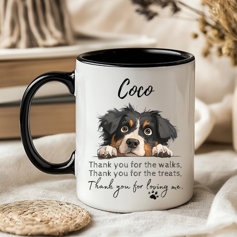 May include: A white ceramic mug with a black handle and interior rim. The mug features a graphic of a tricolor dog with the name Coco printed above it. Below the dog, the text reads: Thank you for the walks, Thank you for the treats, Thank you for loving me.