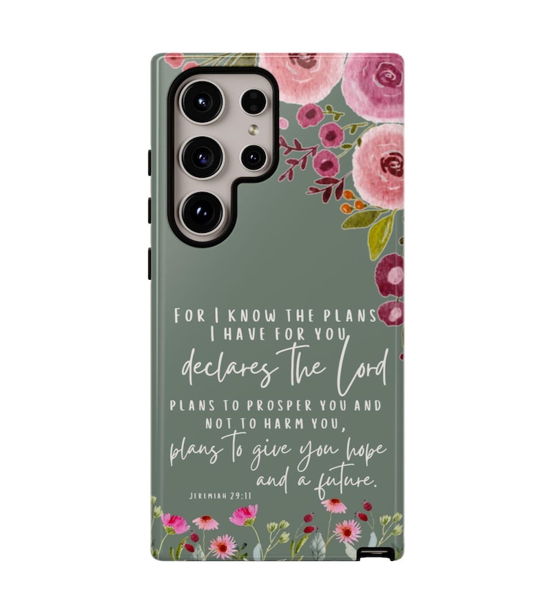 May include: A phone case with a floral design and a quote from Jeremiah 29:11. The case features pink and burgundy flowers on a sage green background. The text reads, "For I know the plans I have for you, declares the Lord, plans to prosper you and not to harm you, plans to give you hope and a future."