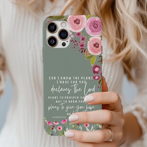 May include: A sage green phone case featuring a floral design with pink and purple watercolor flowers. The case has the text "For I know the plans I have for you, declares The Lord" and a Bible verse reference.