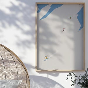 May include: A framed illustration of skiers on a snowy mountain slope. The illustration is in a minimalist style with a white background and blue accents. The skiers are depicted in a simple, geometric style.