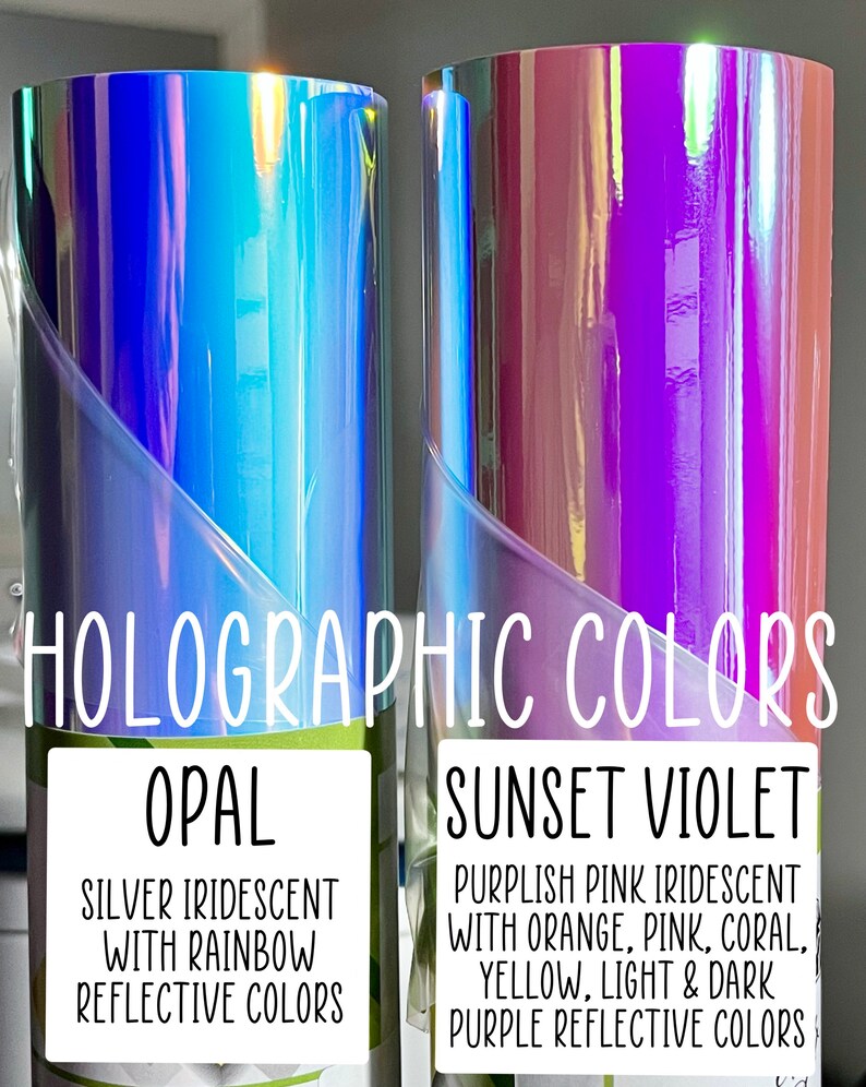 May include: Two rolls of holographic vinyl, one labeled "Opal" and the other "Sunset Violet". The Opal roll is silver iridescent with rainbow reflective colors. The Sunset Violet roll is purplish pink iridescent with orange, pink, coral, yellow, light and dark purple reflective colors.
