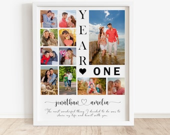 May include: A white framed collage of photos of a couple celebrating their first year of marriage. The collage features the words "YEAR ONE" with a heart symbol between the words. The couple's names, "jonathan amelia", are written below the collage with a heart symbol between the names. The text below the names reads, "The most wonderful thing I decided to do was to share my life and heart with you."