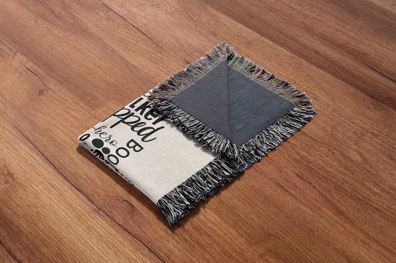 May include: A white woven throw blanket with black text that reads "I like big dogs and I cannot lie". The blanket has a fringe border and is folded in half. The back side of the blanket is a dark gray color.