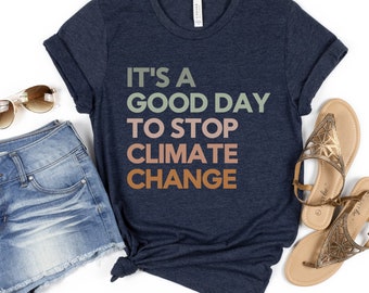 May include: A navy blue t-shirt with the text "It's a good day to stop climate change" in multi-colored lettering. The text is in a gradient of green, pink, and orange.