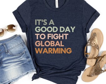 May include: A navy blue t-shirt with the text "It's a good day to fight global warming" in a gradient of green, orange, and red.