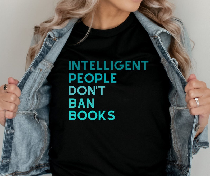 May include: A black t-shirt with a blue gradient design that reads "Intelligent People Don't Ban Books".