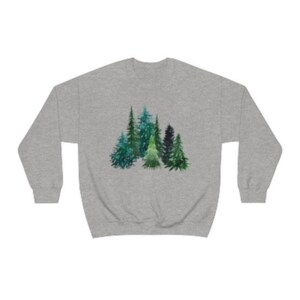 May include: A gray sweatshirt with a watercolor design of a group of green pine trees.