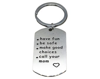May include: Silver keychain with a dog tag shape and the text "have fun, be safe, make good choices, call your mom" with a heart symbol.