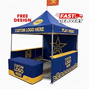 May include: A blue and yellow custom logo tent with the text "FREE DESIGN", "CUSTOM LOGO HERE", and "FAST DELIVERY". The tent has a star graphic and a flag on top. The tent is designed for outdoor events.