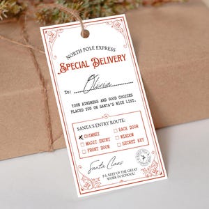 May include: A rectangular gift tag with red and white text and decorative borders. The tag reads "North Pole Express Special Delivery" and includes a space to write a name. It also has a section for Santa's entry route and a message from Santa.