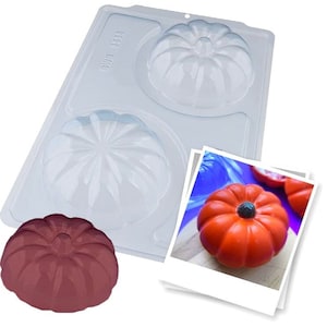 May include: A clear plastic mold for making pumpkin-shaped treats. The mold has three cavities, each shaped like a pumpkin with a stem and ridges. A finished pumpkin-shaped treat is shown in the photo, made with orange and red colored material.