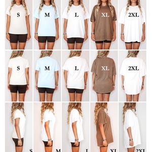 May include: A size fit guide for Comfort Colors 1717 t-shirts. The guide shows various sizes from S to 2XL in different colors, including white, light blue, and brown. The guide also shows the fit of the shirts: Fitted, Regular, Relaxed, Loose, and Oversized.