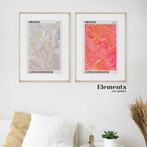 May include: Two framed art prints with abstract swirling patterns in shades of pink, orange, yellow, and gray. The prints are titled "HIGHER" and have the words "CONSCIOUSNESS" printed below the images. The text "Elements / art prints" is printed below the frames.