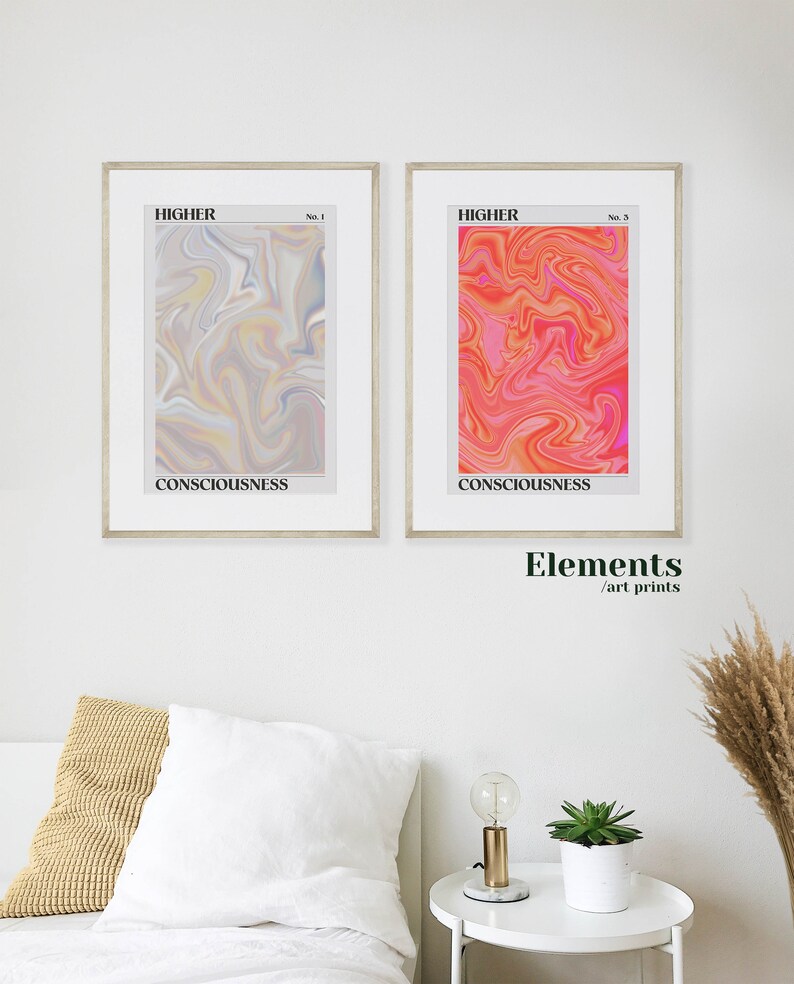 May include: Two framed art prints with abstract swirling patterns in shades of pink, orange, yellow, and gray. The prints are titled "HIGHER" and have the words "CONSCIOUSNESS" printed below the images. The text "Elements / art prints" is printed below the frames.