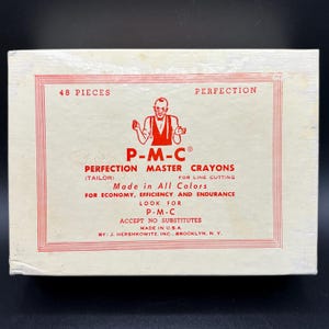May include: A vintage box of P-M-C Perfection Master Crayons, made in the U.S.A. The box is off-white with red text and a red border. The text includes "48 Pieces" and "Perfection". The box features a tailor logo.