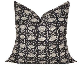 May include: Black and white floral patterned throw pillow with a square shape.
