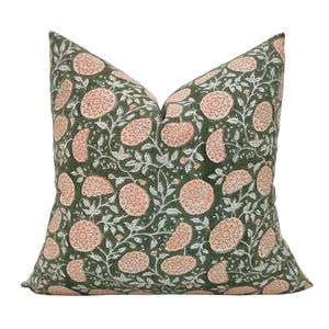 May include: A green cushion with a floral pattern featuring pink flowers and white leaves.