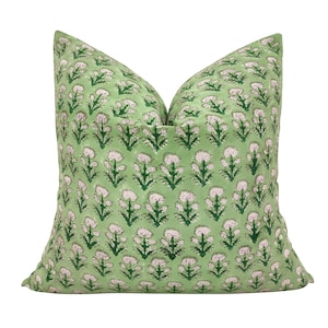 May include: A green cushion with a white and green floral pattern. The cushion is made of a soft, comfortable fabric and has a subtle sheen.