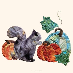 May include: A gray squirrel with a bushy tail stands next to three pumpkins. The pumpkins are orange, blue, and green. The squirrel is looking at the pumpkins. The pumpkins are decorated with leaves and vines.