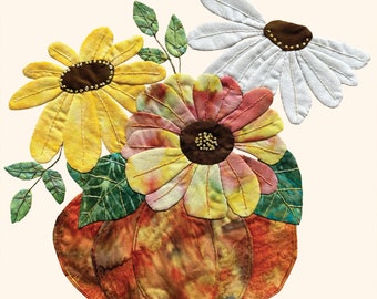 May include: A quilted fabric pumpkin vase with three fabric flowers. The flowers are yellow, pink and white. The pumpkin is orange and brown.