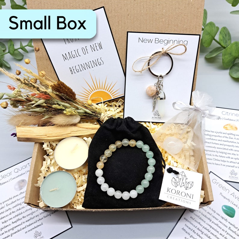 May include: A small box filled with items for spiritual wellness. Includes a bracelet with yellow, green, and white beads, two small candles, a keychain, dried flowers, and cards with text. The box is labeled "Small Box".