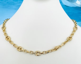 May include: A gold chain necklace with a mariner link design.