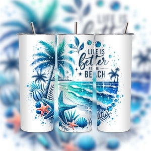 May include: White tumbler with a blue and green beach scene and the text "Life is better at the beach".