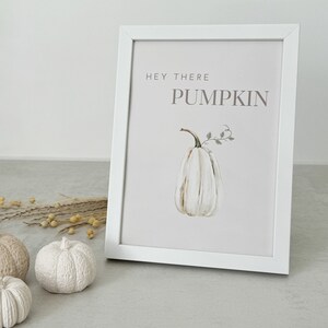 May include: White framed print with the text "Hey there Pumpkin" in brown lettering. A watercolor illustration of a white pumpkin with green leaves is in the center of the print.