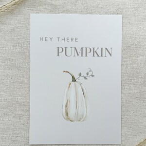 May include: White watercolor pumpkin with a green stem and leaves. The text "Hey There Pumpkin" is written in gray above the pumpkin.