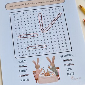 May include: A children's activity page with a word search puzzle and illustrations of rabbits. The word search includes words like "rabbit" and "flavor". Colored pencils are in the background.