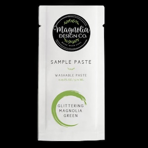 May include: A white sample packet of Magnolia Design Co. washable paste in the color "Glittering Magnolia Green". The packet contains 0.19 fl oz / 5.71 ml of paste.