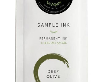 May include: A white sample ink packet with a black and green logo that says "Magnolia Design Co. Made with Love". The packet contains 0.19 fl oz / 5.71 ml of permanent ink in the color "Deep Olive".