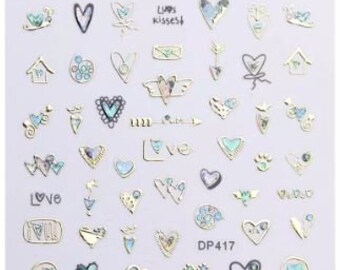 Pode incluir: Folha de adesivos para unhas com uma variedade de desenhos de corações em dourado, prateado e azul. Os adesivos apresentam diferentes padrões, incluindo corações com asas, corações com flechas e corações com a palavra "love". A folha também inclui alguns outros desenhos, como uma casa, uma flor e uma estrela.
