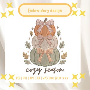 May include: An embroidery design featuring a stack of three pumpkins in orange, cream, and sage green, each adorned with a bow. The design includes small oak leaves, plus signs, and the text "Embroidery design" and "cozy season" with file formats.