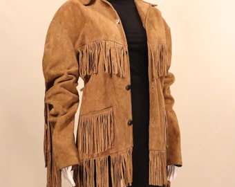May include: A brown suede jacket with fringe detailing on the sleeves, hem, and front. The jacket has a button closure and a pocket on the left side.
