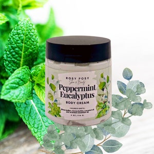 May include: A white jar of Peppermint Eucalyptus body cream with a black lid. The jar is labelled "ROSY POSY Skin & Beauty" and "Peppermint Eucalyptus Body Cream". The ingredients are listed as "Shea butter, cocoa butter, coconut oil and scented essential oil". The jar is 4 oz / 114 g.