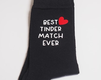 Könnte beinhalten: Schwarze Socken mit weißem Text, der "Best Tinder Match Ever" lautet, und einem roten Herzen.