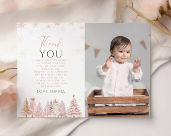 May include: A personalized thank you card with a photo of a baby. The card features the text "Thank You" in a script font, with a message below. The card has a watercolor design of pink trees and snowflakes.