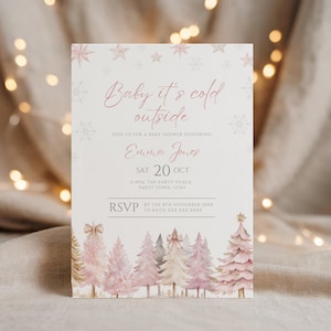 May include: A baby shower invitation with the text "Baby it's cold outside" in pink script. The invitation features watercolor illustrations of pink and gold Christmas trees at the bottom and snowflakes at the top. The details include the honoree's name, date, time, and RSVP information.