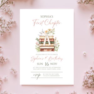 May include: A white invitation card with the text "SOPHIA'S First Chapter" in a script font. The card features a watercolor illustration of a stack of books tied with a ribbon and surrounded by flowers. The text "Sophia's 1st Birthday" is also included.
